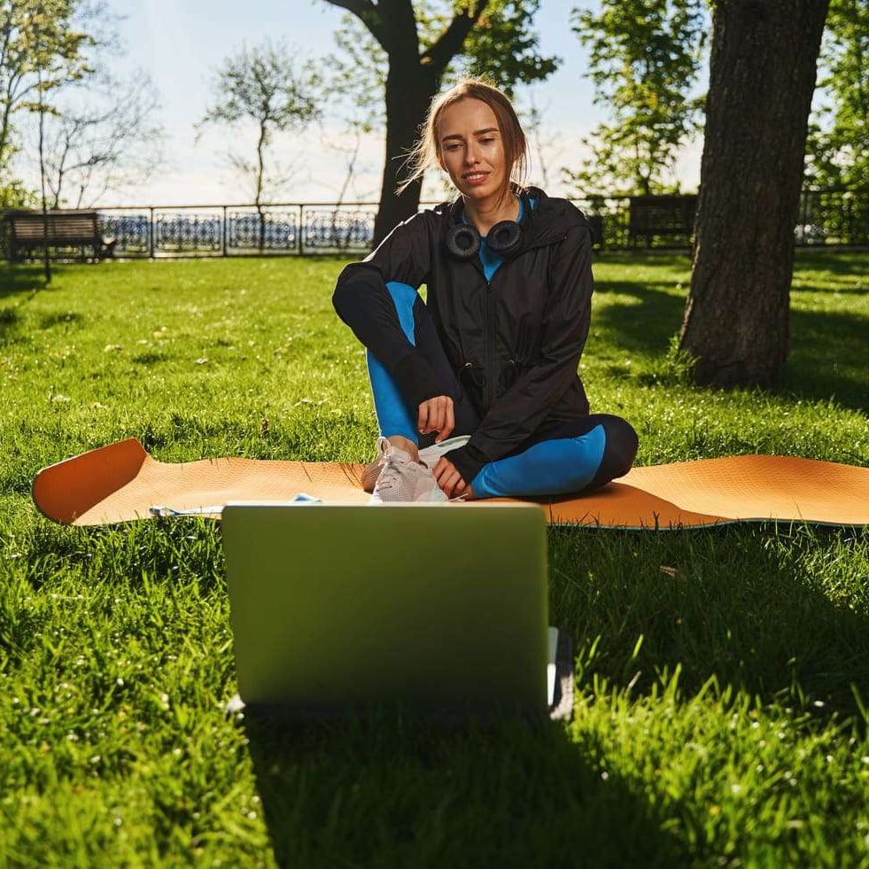 happy-young-woman-training-online-in-open-air-2024-10-18-10-11-23-utc