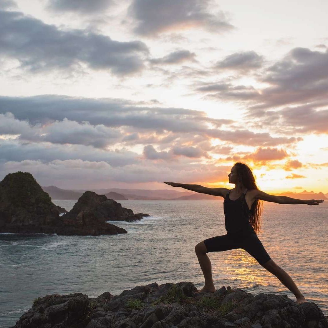 young-slim-woman-practicing-yoga-at-sunset-with-be-2024-09-14-04-46-32-utc